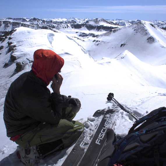 Skier on top of mountain looking down